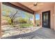 Covered patio offers scenic views of the landscaped backyard and nearby green space at 4365 S Columbine Way, Gold Canyon, AZ 85118