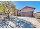Exterior showcasing a two-car garage, desert landscaping, and a covered front entrance at 4365 S Columbine Way, Gold Canyon, AZ 85118