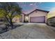 Exterior showcasing a two-car garage, desert landscaping, and a covered front entrance at 4365 S Columbine Way, Gold Canyon, AZ 85118