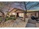 Back of the home showing covered patio, outdoor kitchen, and desert landscaping at sunset at 4365 S Columbine Way, Gold Canyon, AZ 85118