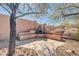 Backyard showcases outdoor fireplace with seating and desert landscaping at 4365 S Columbine Way, Gold Canyon, AZ 85118