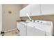 Bright laundry room features modern washer, dryer, granite counters and ample overhead storage cabinets at 4365 S Columbine Way, Gold Canyon, AZ 85118