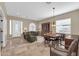 Open-concept living area with tile flooring, a dining table, and plenty of natural light at 4365 S Columbine Way, Gold Canyon, AZ 85118