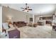Spacious living area with a ceiling fan, tile flooring, and seamless kitchen access at 4365 S Columbine Way, Gold Canyon, AZ 85118