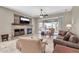Bright living room with a stone fireplace and sliding doors leading to a covered outdoor patio at 4365 S Columbine Way, Gold Canyon, AZ 85118