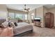 Comfortable bedroom with large windows, carpet floors, and a sitting area with a television at 4365 S Columbine Way, Gold Canyon, AZ 85118