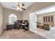 Bright office featuring a ceiling fan, arched window and an open doorway to a sitting room or second office space at 4365 S Columbine Way, Gold Canyon, AZ 85118