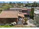 Aerial view showing the property's red tile roof, lush landscaping, and outdoor dining area at 4448 E Camelback Rd # 16, Phoenix, AZ 85018