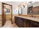 Bathroom with dual sinks, granite countertops, and decorative tile, with access to the shower and toilet area at 4448 E Camelback Rd # 16, Phoenix, AZ 85018