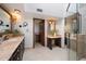 Luxurious bathroom with dual vanities, a separate makeup area, and a glass-enclosed shower at 4448 E Camelback Rd # 16, Phoenix, AZ 85018
