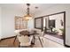 Charming dining area with an elegant chandelier and direct access to a serene outdoor courtyard with a water feature at 4448 E Camelback Rd # 16, Phoenix, AZ 85018