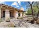 Inviting exterior view showcasing the home's architecture, lush landscaping, and charming entrance with stone accents at 4448 E Camelback Rd # 16, Phoenix, AZ 85018