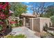 Charming exterior view featuring a decorative iron gate, stone accents, and lush greenery, creating a welcoming entrance at 4448 E Camelback Rd # 16, Phoenix, AZ 85018