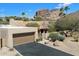 Exterior shot of the property showcasing the attached garage and well-maintained desert landscaping at 4448 E Camelback Rd # 16, Phoenix, AZ 85018