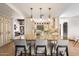 Gourmet kitchen with granite island, breakfast bar, custom cabinets, and modern appliances for entertaining at 4448 E Camelback Rd # 16, Phoenix, AZ 85018
