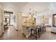 Open-concept kitchen with a granite island, breakfast bar seating, custom cabinetry, and modern pendant lighting at 4448 E Camelback Rd # 16, Phoenix, AZ 85018