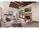 Elegant living room features a stone fireplace, wood-beamed ceilings, and stylish seating at 4448 E Camelback Rd # 16, Phoenix, AZ 85018