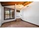 Bright living room showcasing stone floors and vaulted wood beam ceiling at 4448 E Camelback Rd # 16, Phoenix, AZ 85018