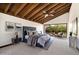 This primary bedroom features vaulted beamed ceilings and a large window overlooking a landscaped patio at 4448 E Camelback Rd # 16, Phoenix, AZ 85018