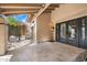 Inviting covered patio features decorative iron doors and a serene seating area with lush landscaping at 4448 E Camelback Rd # 16, Phoenix, AZ 85018