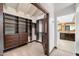 Spacious walk-in closet with custom built-ins and views to an ensuite bathroom at 4448 E Camelback Rd # 16, Phoenix, AZ 85018