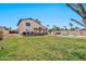 Expansive backyard with lush lawn, covered patio, and inviting pool area perfect for relaxing and entertaining at 4530 E Vista Dr, Phoenix, AZ 85032
