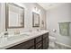 Well lit bathroom with double sinks, modern vanity, patterned tile floor, and neutral wall color at 4530 E Vista Dr, Phoenix, AZ 85032