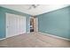 Bedroom featuring neutral carpet, a ceiling fan, and fresh, light-blue paint at 4530 E Vista Dr, Phoenix, AZ 85032