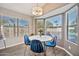 Charming dining area with bright windows offering views of the pool area and a modern chandelier at 4530 E Vista Dr, Phoenix, AZ 85032