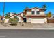 Inviting two-story home with a classic design, featuring a two-car garage and mature landscaping at 4530 E Vista Dr, Phoenix, AZ 85032