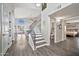 Spacious home foyer with staircase, wood floors, and open view to the dining and living areas at 4530 E Vista Dr, Phoenix, AZ 85032