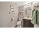 Cozy half bathroom with dark wood vanity, toilet, and neutral wall color at 4530 E Vista Dr, Phoenix, AZ 85032