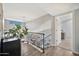 Second story hallway featuring hardwood floors, view into living room, and natural light at 4530 E Vista Dr, Phoenix, AZ 85032