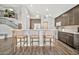 Modern kitchen with a breakfast bar, pendant lighting, and views of the staircase and upper level at 4530 E Vista Dr, Phoenix, AZ 85032