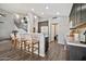 Contemporary kitchen with a breakfast bar, pendant lights, and open layout towards the staircase at 4530 E Vista Dr, Phoenix, AZ 85032