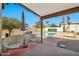 Covered patio with view of private pool, mature landscaping, and lounge area at 4530 E Vista Dr, Phoenix, AZ 85032