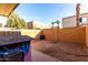 Enclosed backyard with a brick fence, dirt ground, and shade trees at 4615 E Southgate Ave, Phoenix, AZ 85040