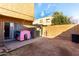 Fenced backyard features a small dog house and storage shed, providing outdoor space and storage at 4615 E Southgate Ave, Phoenix, AZ 85040