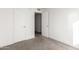 Bedroom featuring two doors, carpet flooring, and neutral paint at 4615 E Southgate Ave, Phoenix, AZ 85040
