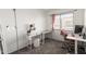 Bright bedroom with a vanity, desk, and natural light from a window at 4615 E Southgate Ave, Phoenix, AZ 85040
