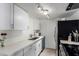 Bright kitchen with white cabinets, countertops, and stainless steel appliances at 4615 E Southgate Ave, Phoenix, AZ 85040
