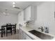 Updated kitchen with white cabinets, quartz countertops, and stainless sink at 4615 E Southgate Ave, Phoenix, AZ 85040