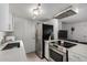 Modern kitchen featuring stainless steel appliances, light countertops, and contemporary lighting fixtures at 4615 E Southgate Ave, Phoenix, AZ 85040
