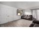 Living room featuring tile floors, sofa and a window with natural light at 4615 E Southgate Ave, Phoenix, AZ 85040
