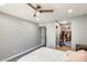 This bedroom features a walk-in closet, neutral walls, vinyl floors, and a stylish ceiling fan at 4730 W Northern Ave # 1102, Glendale, AZ 85301
