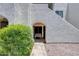 Inviting entrance features an arched doorway and a bench for relaxing outdoors at 4730 W Northern Ave # 1102, Glendale, AZ 85301