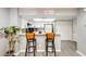 Bright kitchen with modern white cabinets, a breakfast bar, and light-colored countertops at 4730 W Northern Ave # 1102, Glendale, AZ 85301