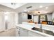 Open concept kitchen with white countertops, stainless steel sink, and view to the living room at 4730 W Northern Ave # 1102, Glendale, AZ 85301