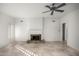 Bright living room showcases a stone fireplace, ceiling fan, neutral walls, and tiled floors, creating an inviting atmosphere at 4744 E Desert Park Pl, Paradise Valley, AZ 85253