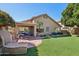 The exterior backyard features custom BBQ, covered patio, and well-maintained green lawn at 5102 E Libby St, Scottsdale, AZ 85254